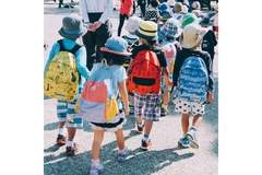 Image Young children walking to school with backpacks